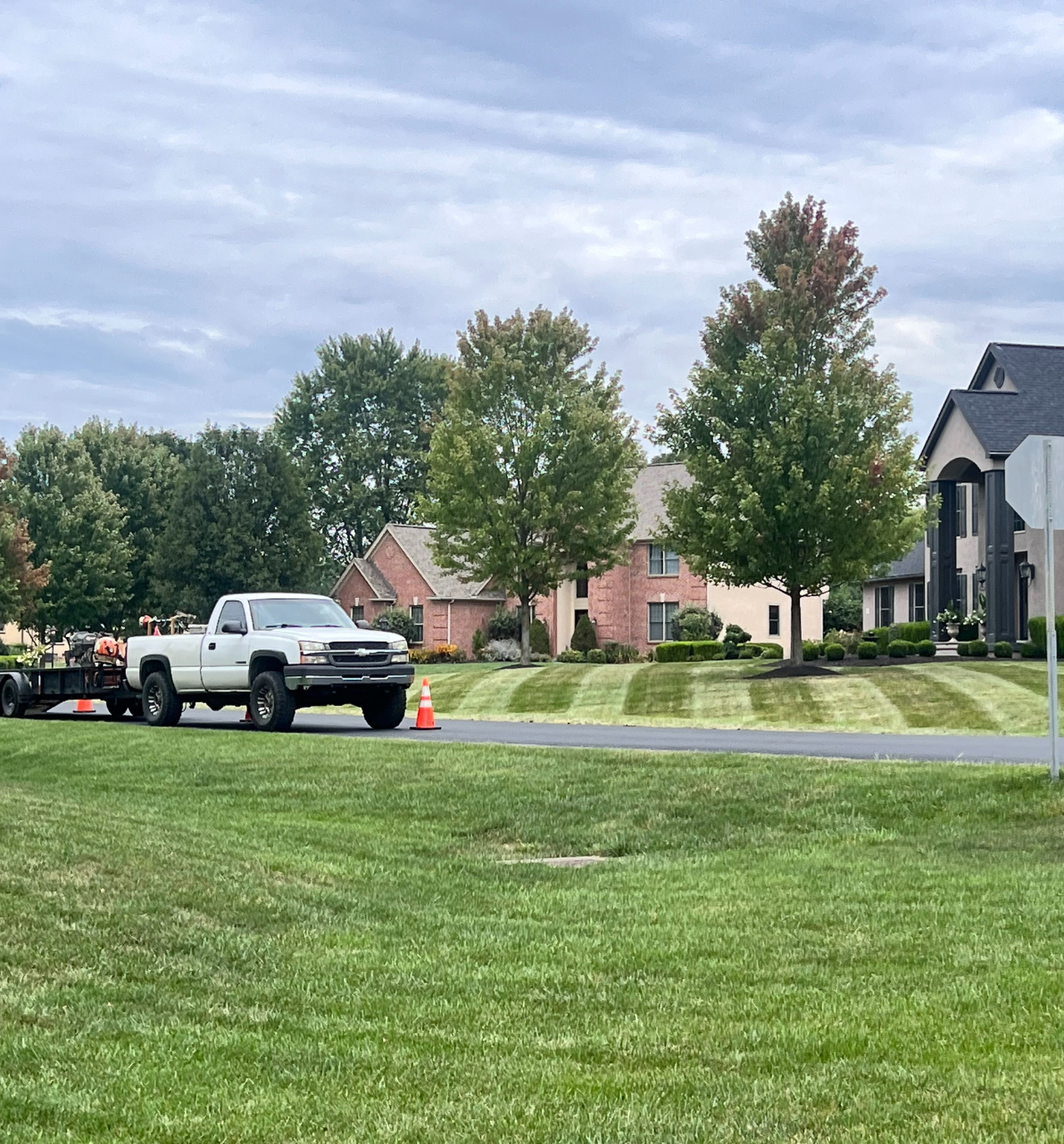 OLS truck beside a freshly striped, mowed lawn